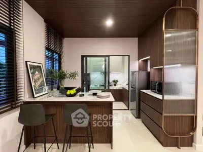 Modern kitchen with sleek wooden cabinetry and breakfast bar