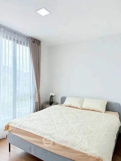 Bright and airy bedroom with large window and modern decor
