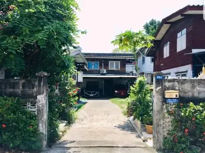 Charming suburban home with lush greenery and spacious driveway, perfect for family living.
