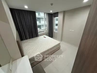 Modern bedroom with large window and minimalist design in urban apartment