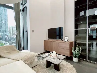 Modern living room with city view, sleek furniture, and cozy decor in a high-rise apartment.