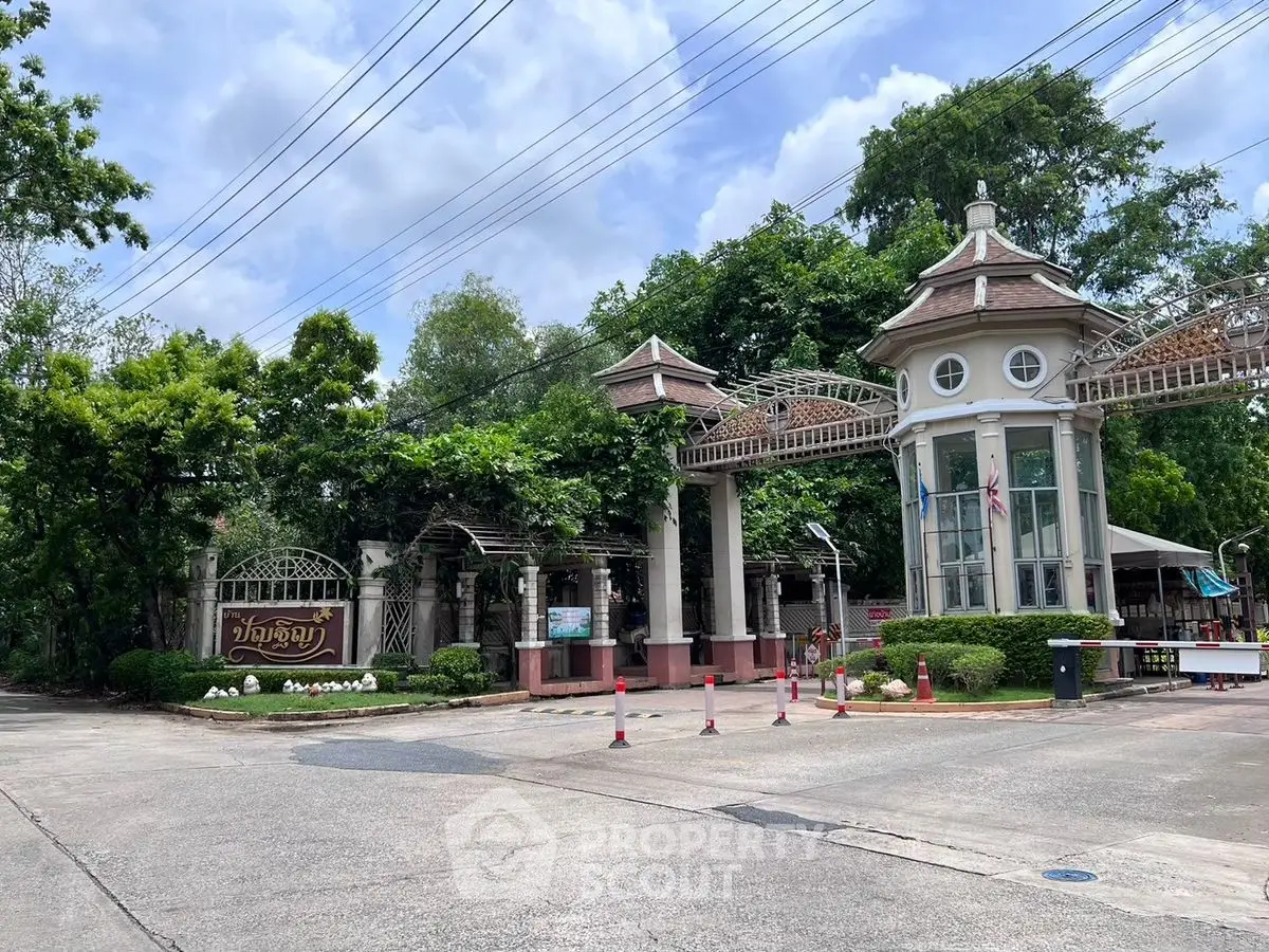 Charming gated entrance with lush greenery and elegant architecture