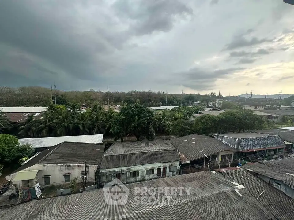 Scenic view of residential rooftops under a dramatic cloudy sky
