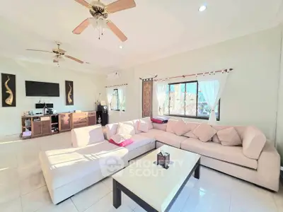 Spacious living room with modern decor and large windows for natural light