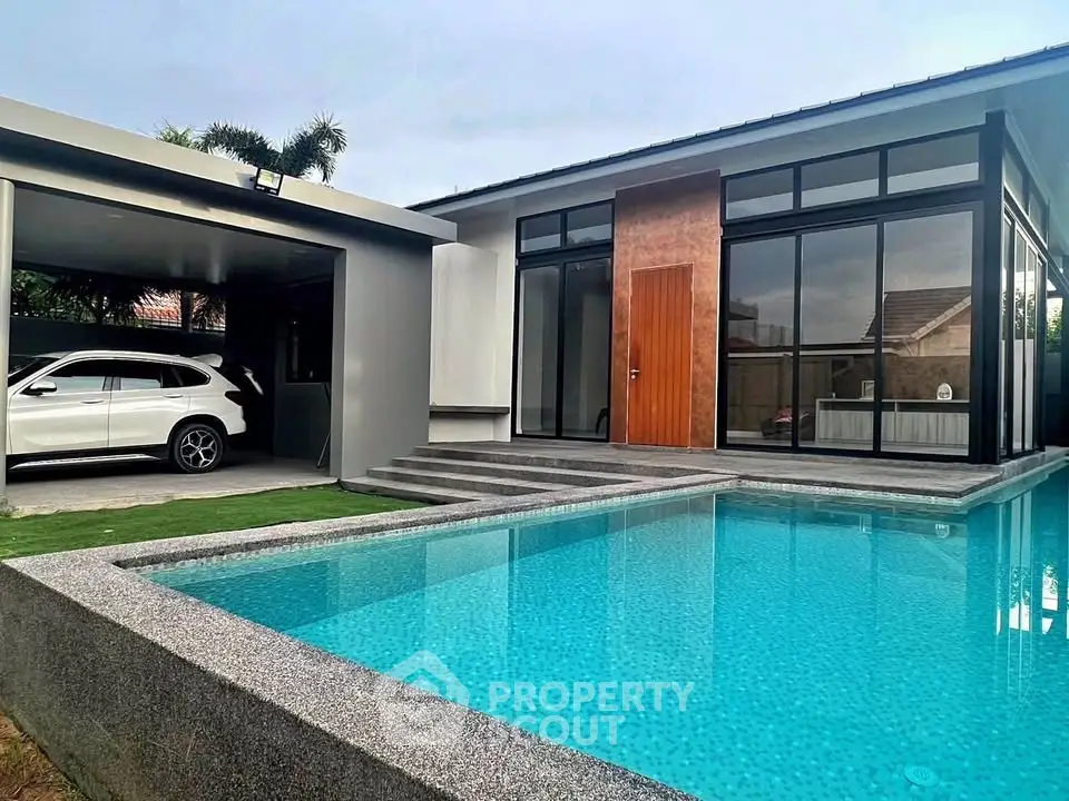 Modern luxury home with sleek pool and carport, showcasing contemporary architecture and design.