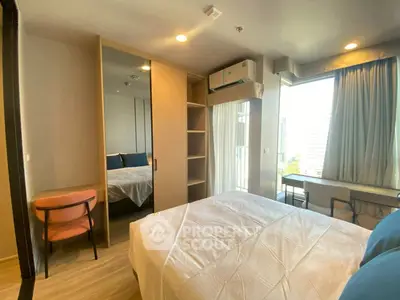 Modern bedroom with large window and city view, featuring a cozy bed, built-in wardrobe, and air conditioning.