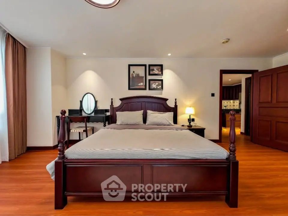 Spacious bedroom with elegant wooden furniture and cozy lighting
