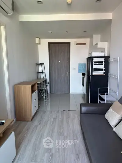 Modern apartment interior with compact kitchen and stylish living area.