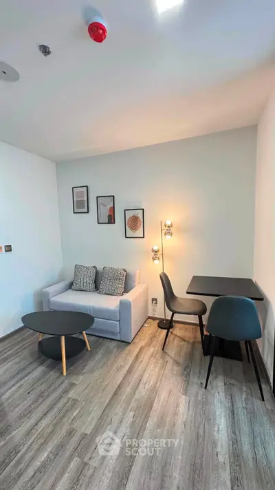 Modern living room with stylish furniture and decor, featuring a cozy sofa and chic dining area.