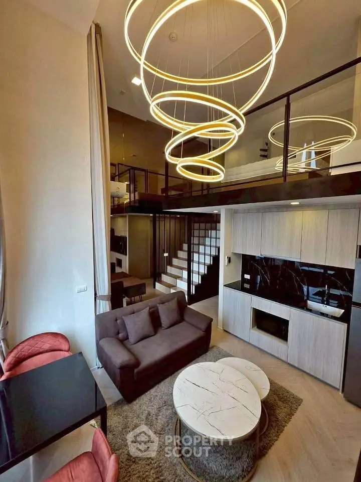 Luxurious modern living room with high ceilings and stylish lighting in a loft apartment.