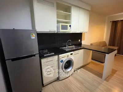 Modern kitchen with sleek appliances and open layout in cozy apartment