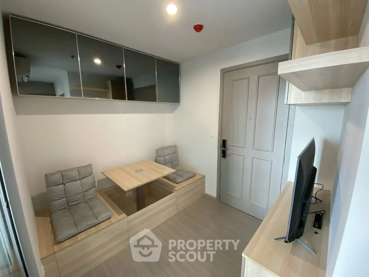 Modern compact living room with built-in seating and wall-mounted TV