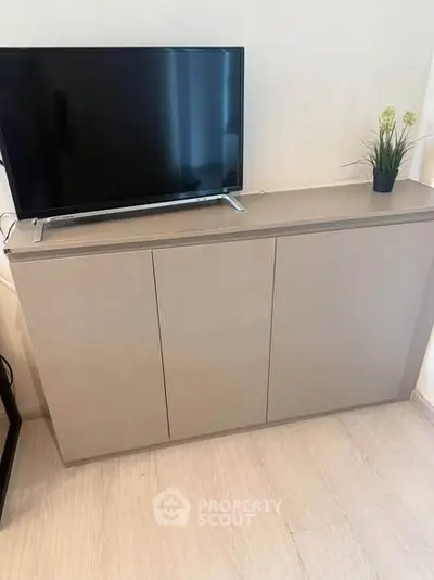 Modern living room with sleek TV stand and flat-screen TV, perfect for contemporary home entertainment setup.