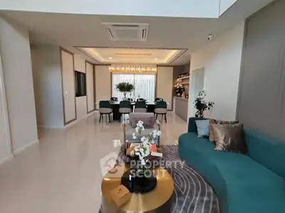 Luxurious open living and dining area with elegant decor and modern furniture.