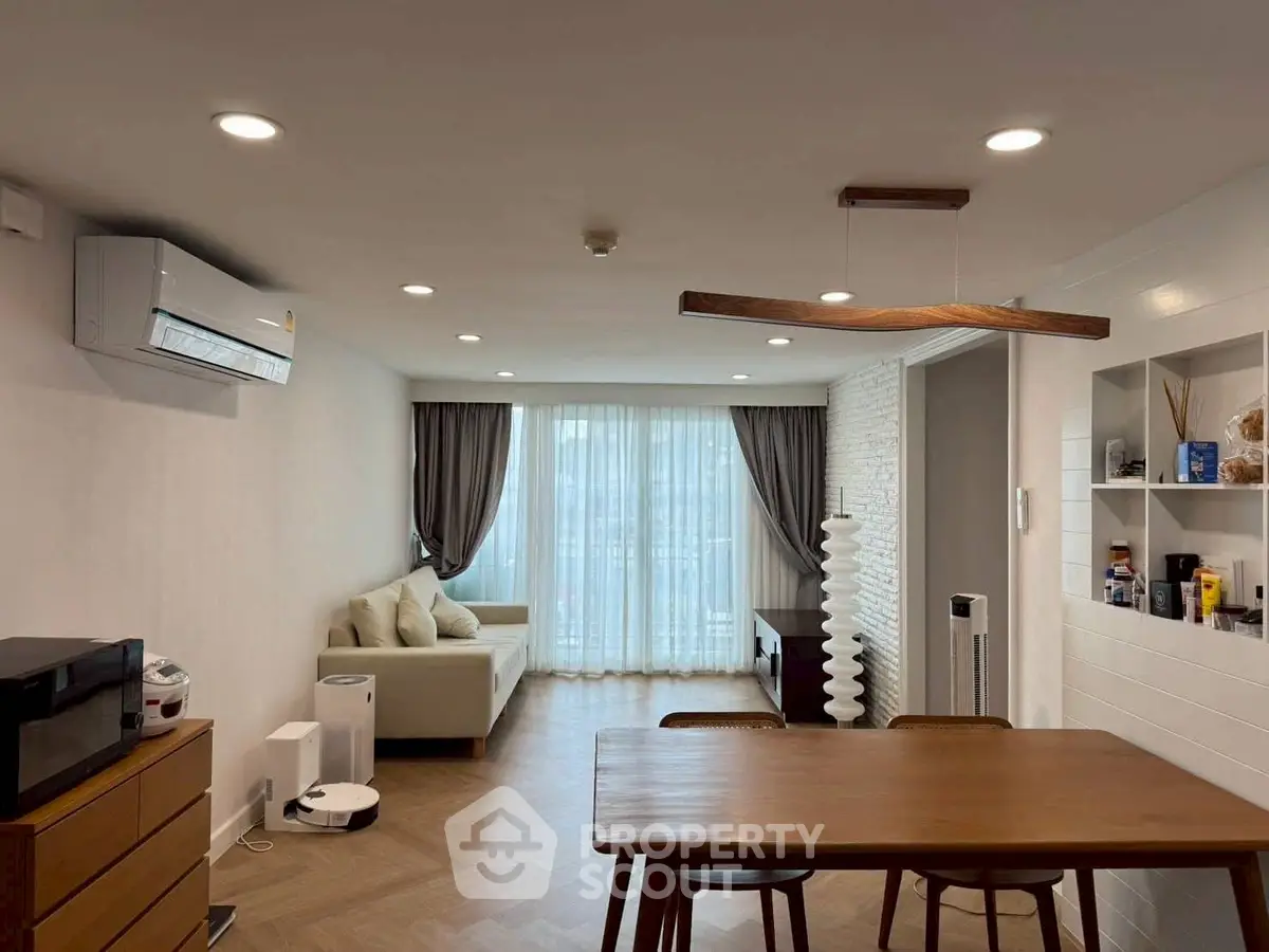 Stylish modern living room with elegant dining area and natural light