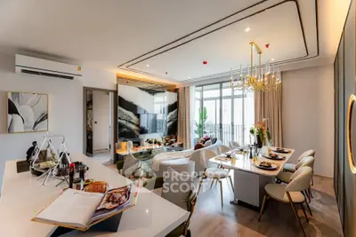 Luxurious open-plan living and dining area with modern decor and elegant lighting in a high-end apartment.