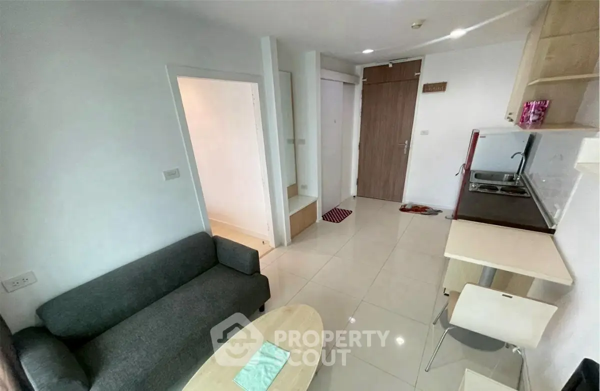 Modern compact living room with kitchenette in a cozy apartment