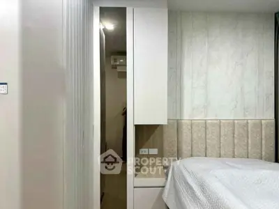 Modern bedroom with stylish headboard and built-in wardrobe, showcasing elegant interior design.