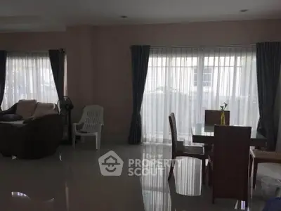 Spacious living room with elegant curtains and modern furniture