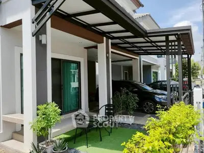 Modern house exterior with carport and small garden area