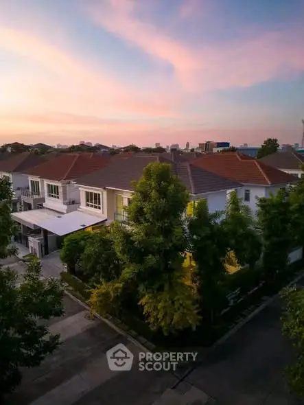 Charming suburban home with lush greenery and sunset view, perfect for serene living.