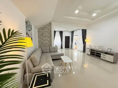 Spacious modern living room with elegant decor and ample natural light.
