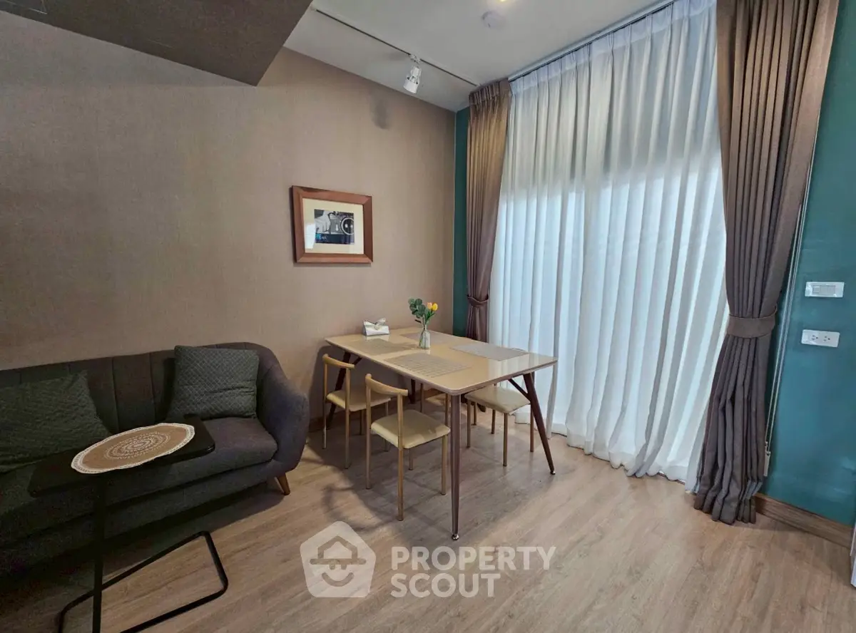 Cozy living room with elegant curtains and modern furniture, perfect for relaxation and dining.