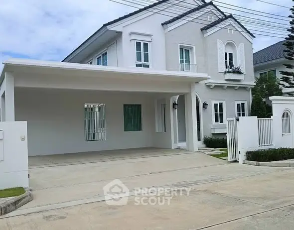 Elegant two-story white house with spacious driveway and modern design.