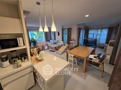 Spacious open-layout living room with modern kitchen and dining area, perfect for family gatherings.