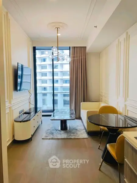 Modern living room with elegant decor and city view, featuring stylish furniture and large window.