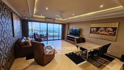 Spacious living room with modern decor and stunning sea view balcony.