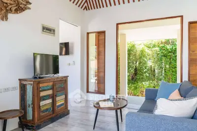 Charming living room with rustic decor and garden view, featuring cozy seating and natural light.