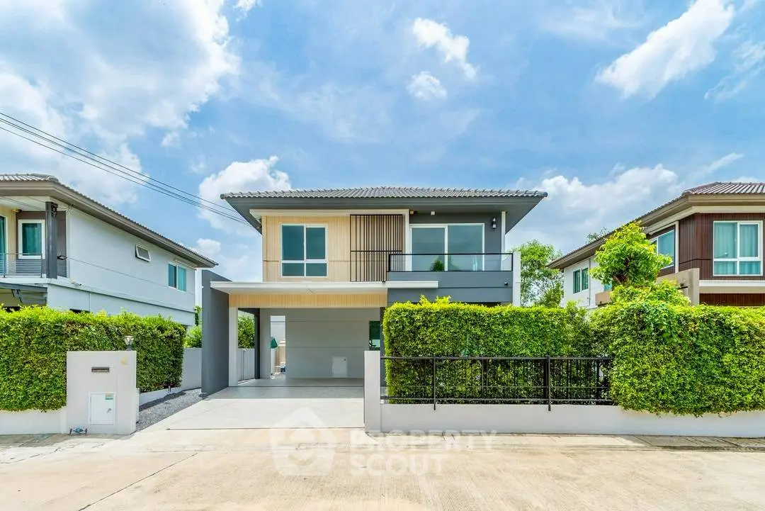 Modern two-story house with lush greenery and spacious driveway