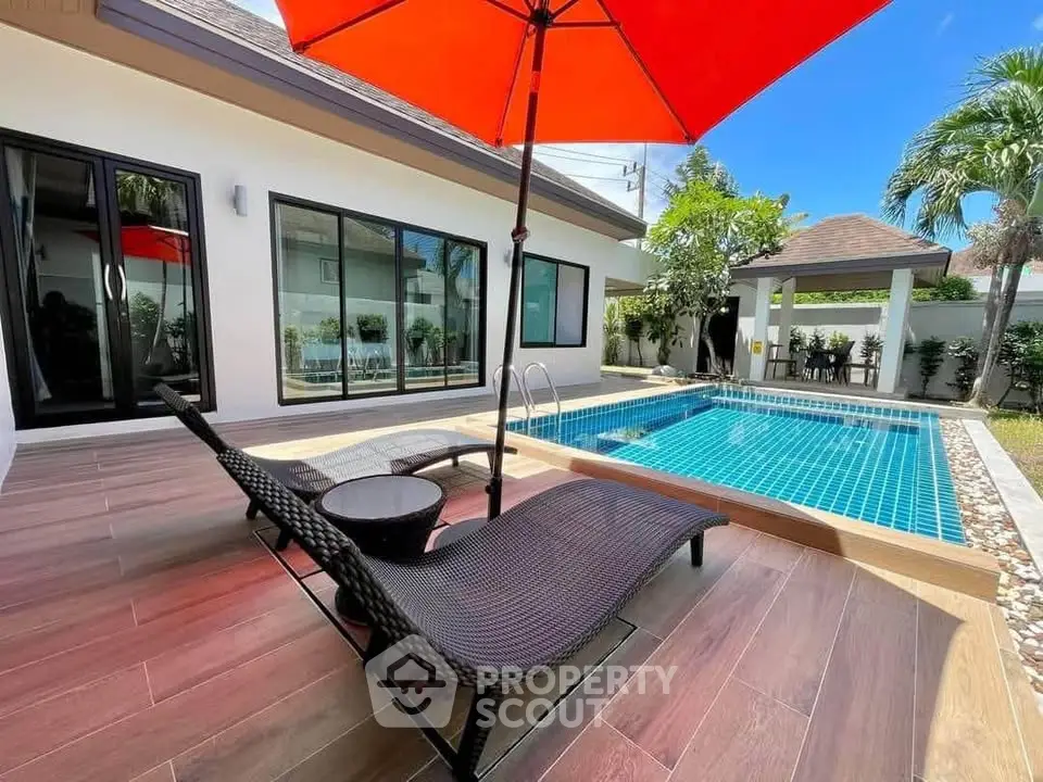 Luxurious villa with private pool and sun loungers, perfect for relaxation and entertainment.