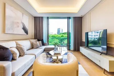 Luxurious living room with modern decor and stunning city view from balcony.