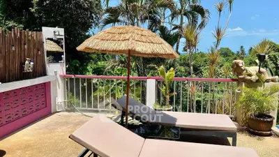 Tropical balcony with sun loungers and lush greenery view