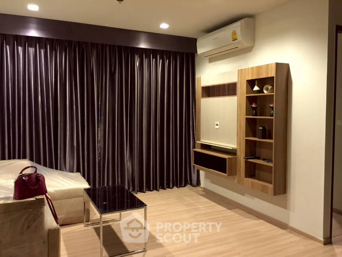 Modern living room with sleek furniture and elegant curtains, showcasing a stylish and cozy atmosphere.