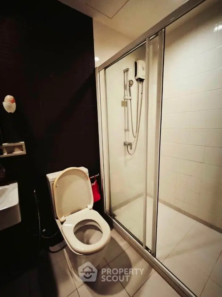 Modern bathroom with glass shower enclosure and sleek fixtures.