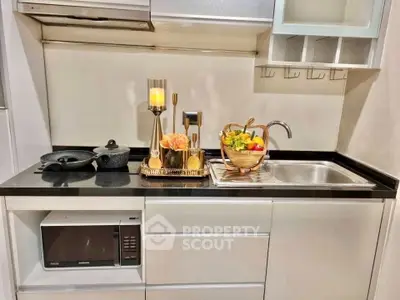 Modern compact kitchen with sleek appliances and elegant decor