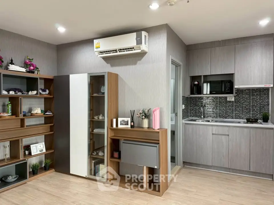 Modern kitchen with sleek cabinetry and integrated appliances in stylish apartment.