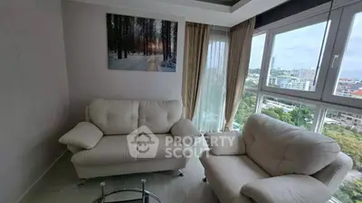 Cozy living room with white sofas and scenic window view