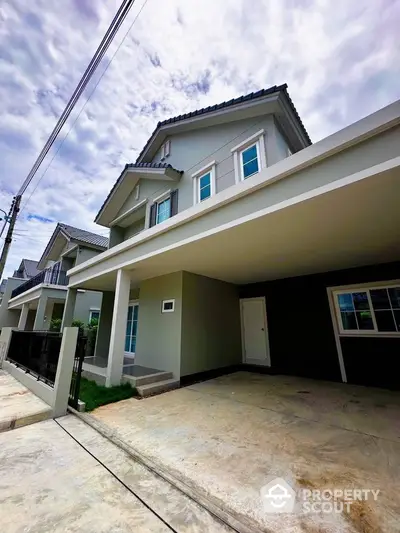 Modern two-story house with spacious driveway and contemporary design