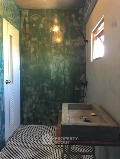 Unique rustic bathroom with concrete sink and artistic wall design, perfect for modern living.