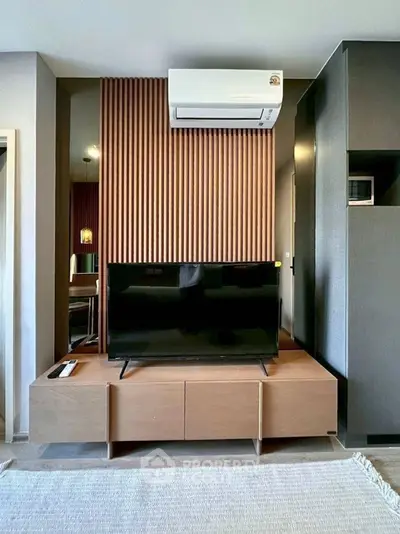 Modern living room with sleek TV setup and stylish wood paneling