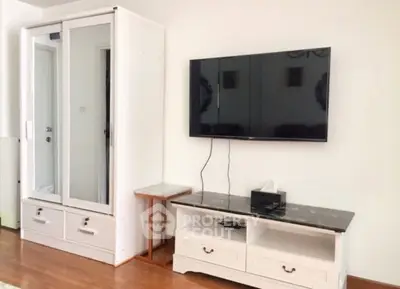 Modern living room with sleek TV setup and stylish storage solutions.