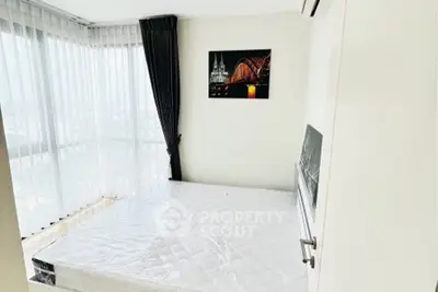 Bright bedroom with large windows and modern decor