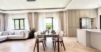 Spacious open-plan living and dining area with modern kitchen and elegant decor.