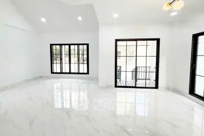 Spacious modern living room with marble flooring and large windows