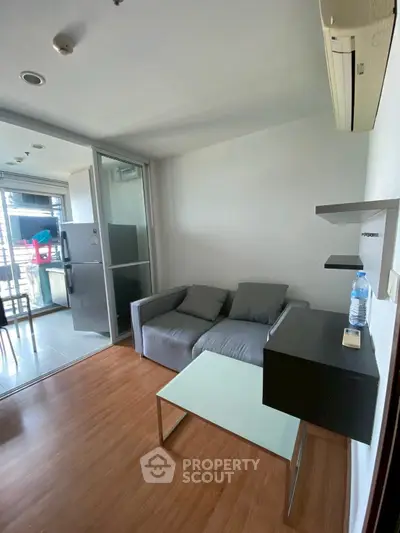 Modern living room with cozy sofa and sleek kitchen area