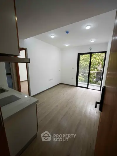 Modern apartment interior with open layout and balcony view